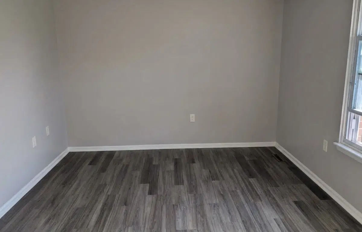Bedroom with window and modern flooring.