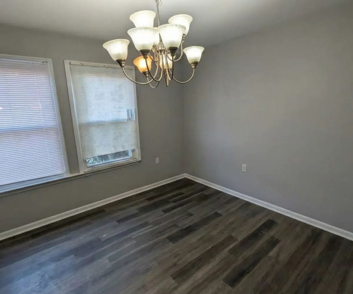 Townhome dining room with hanging lights and modern flooring.