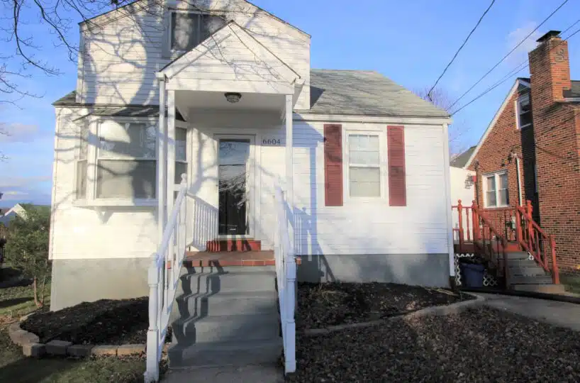 Home with white siding and red window shutters.