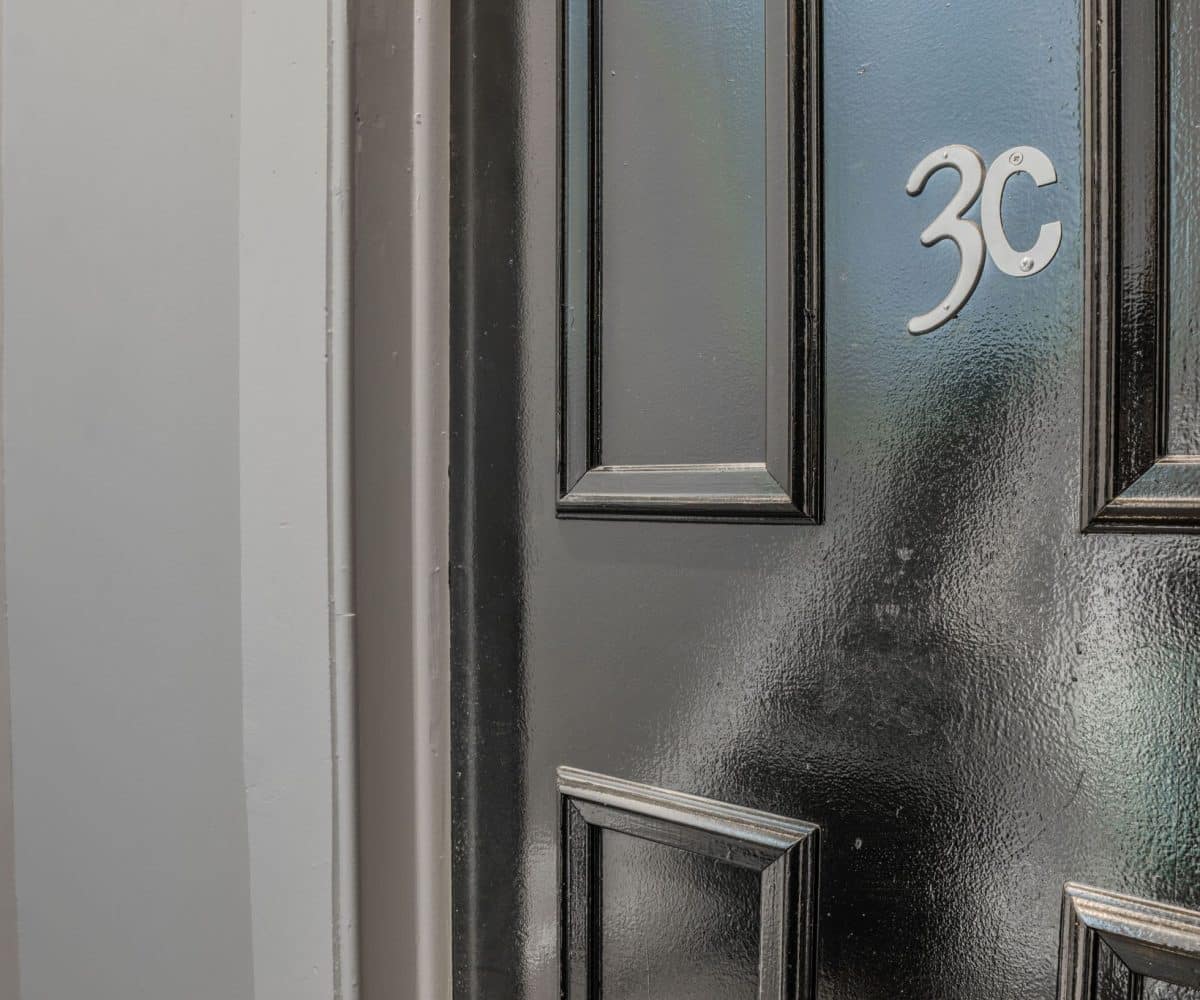 Black apartment front door with 3C lettering.