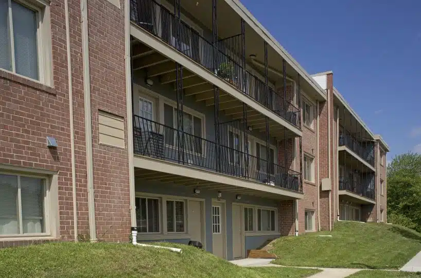 Overlook Apts Exterior with blue siding and beige front doors.