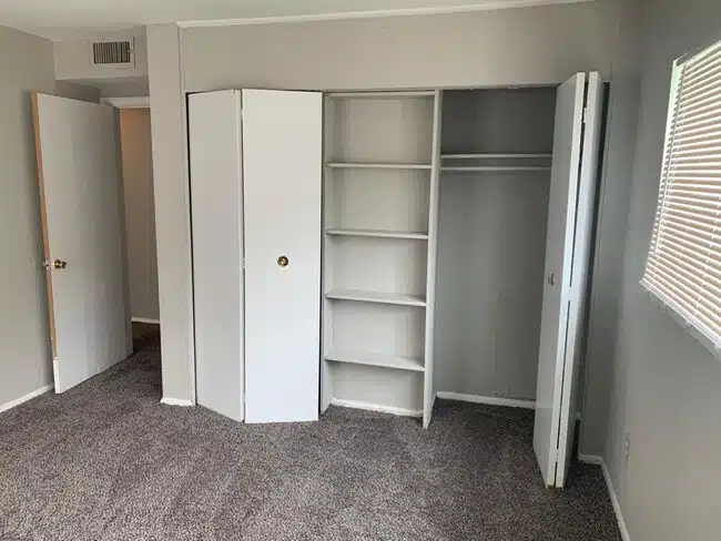 Bedroom with carpet and closets.