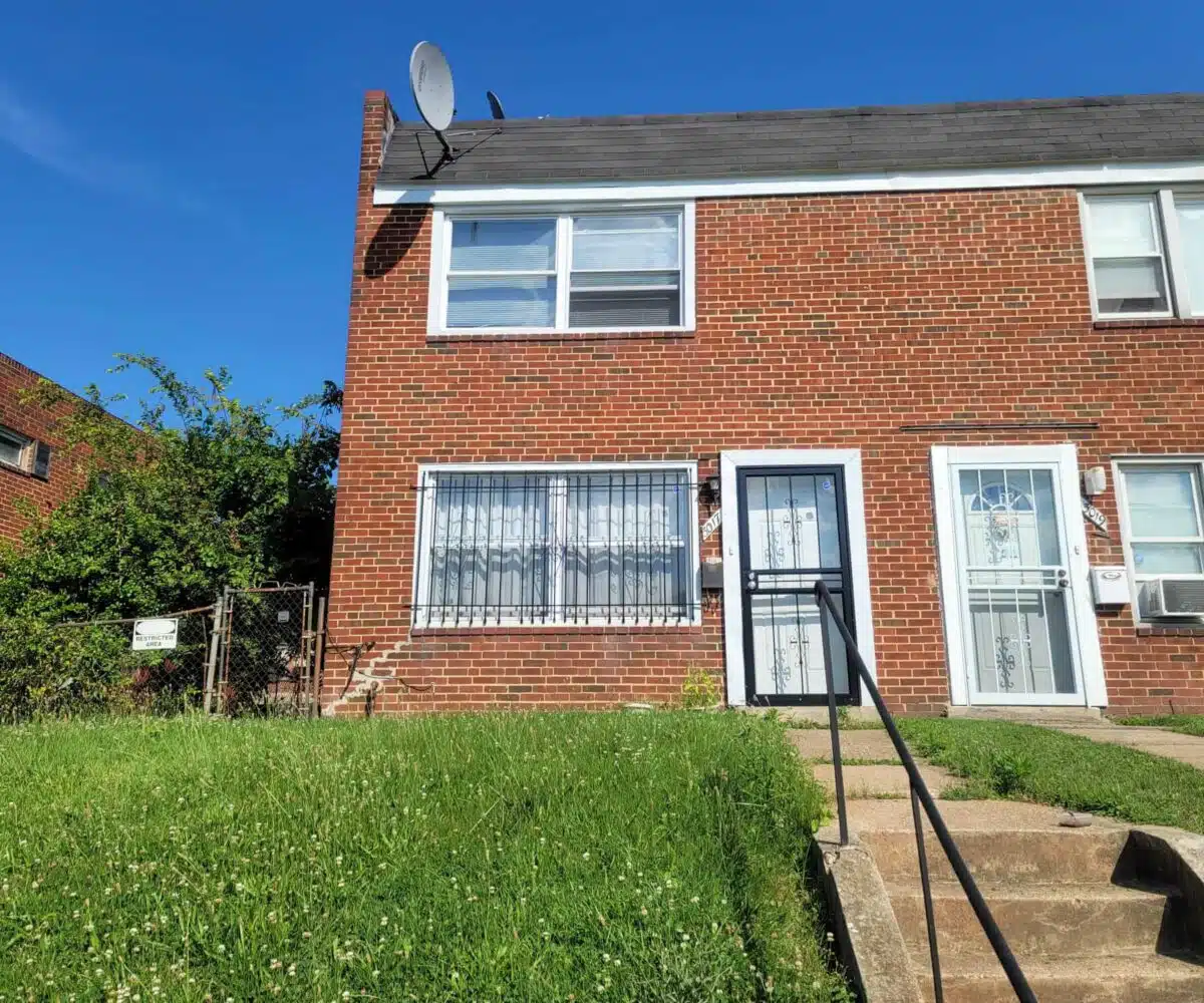 Exterior of red brick townhome and front stairs.