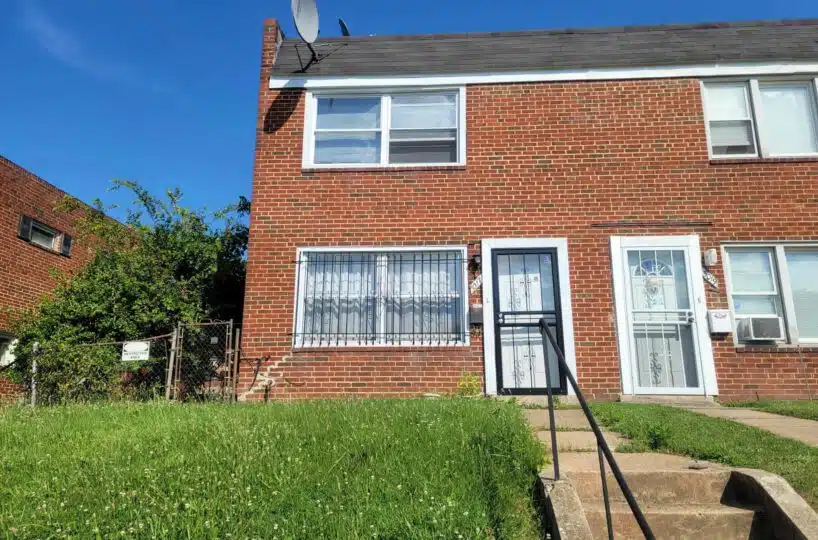 Exterior of red brick townhome and front stairs.