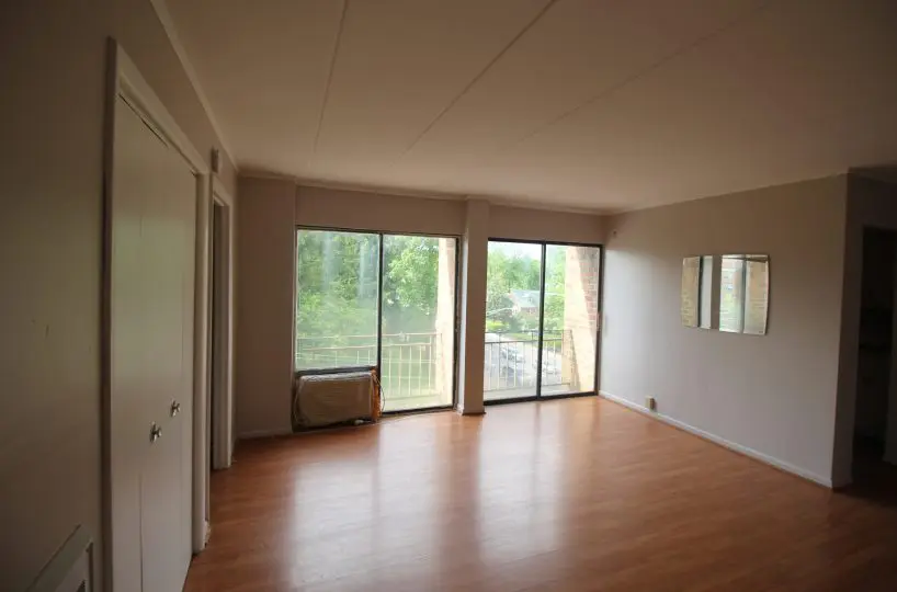 Park Heights Ave living room with hardwood floors, and large picture windows.