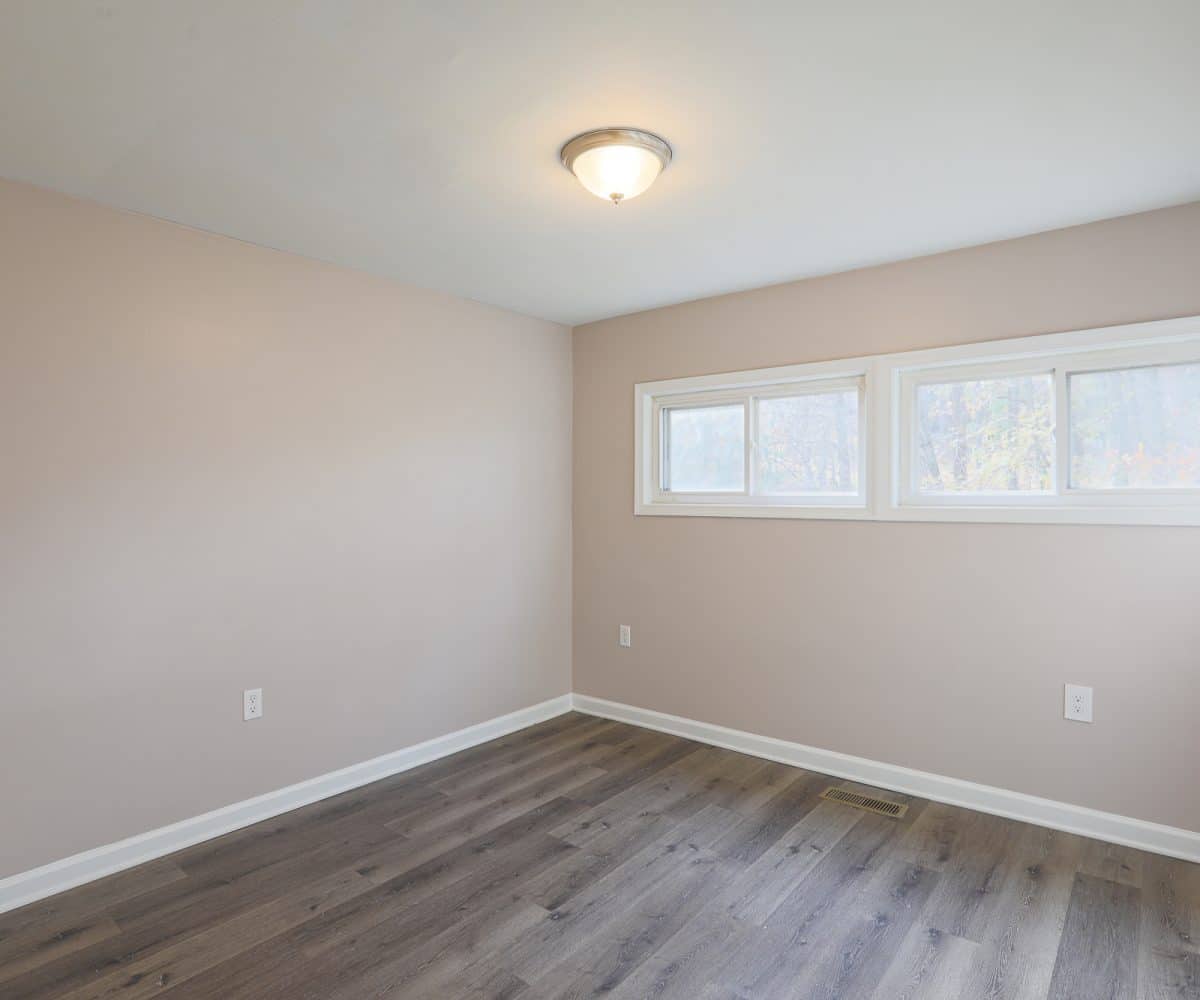 Bedroom with light fixture and windows.