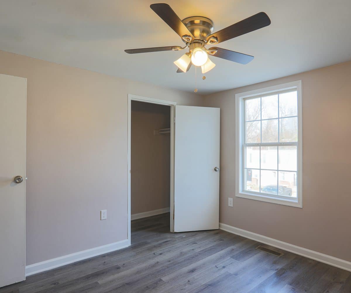 Bedroom with closet and window.