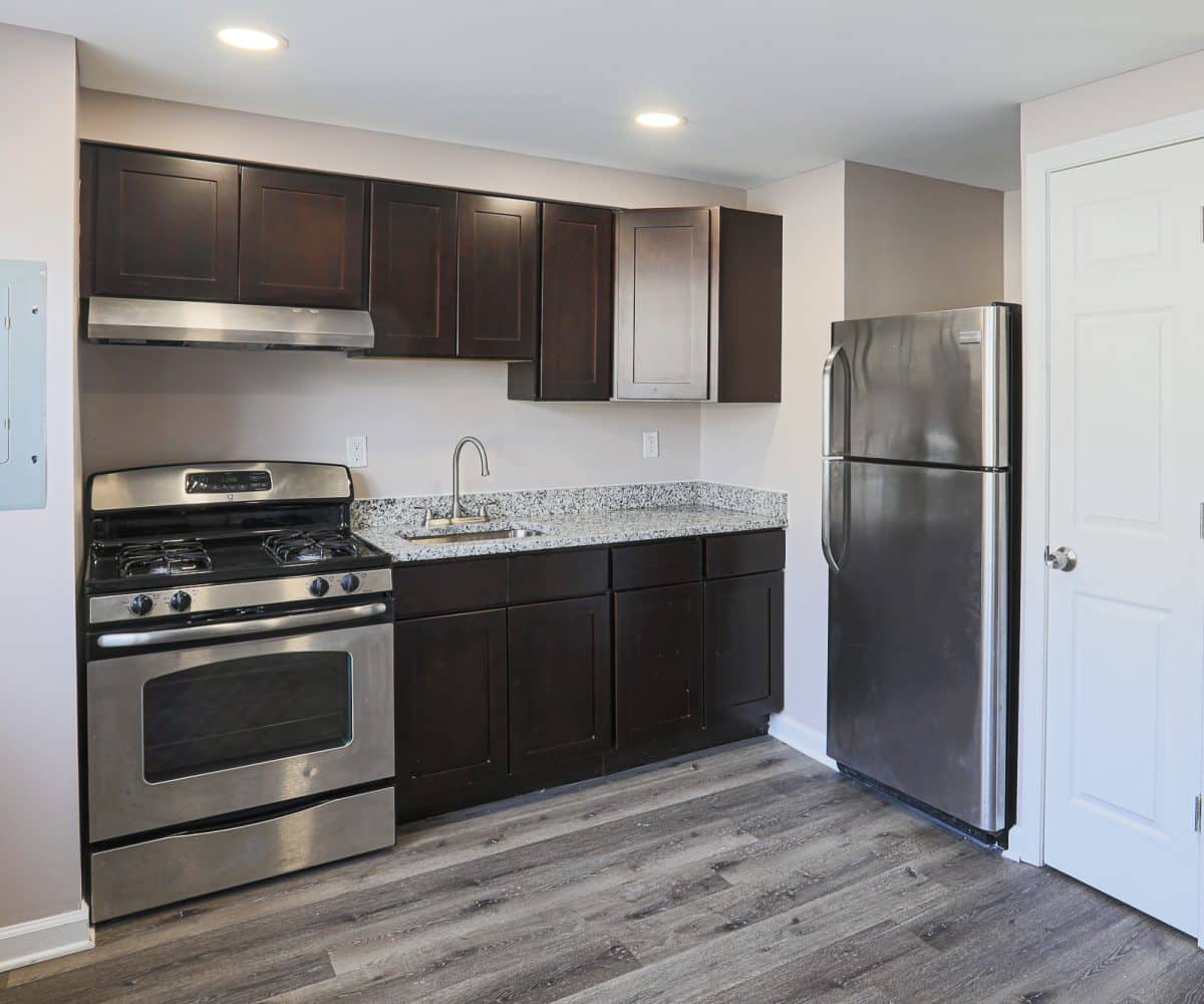 Eat-in kitchen with stainless steel appliances, granite countertops and wood cabinets.