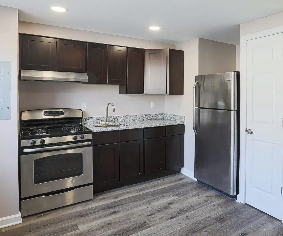 Eat-in kitchen with stainless steel appliances, granite countertops and wood cabinets.