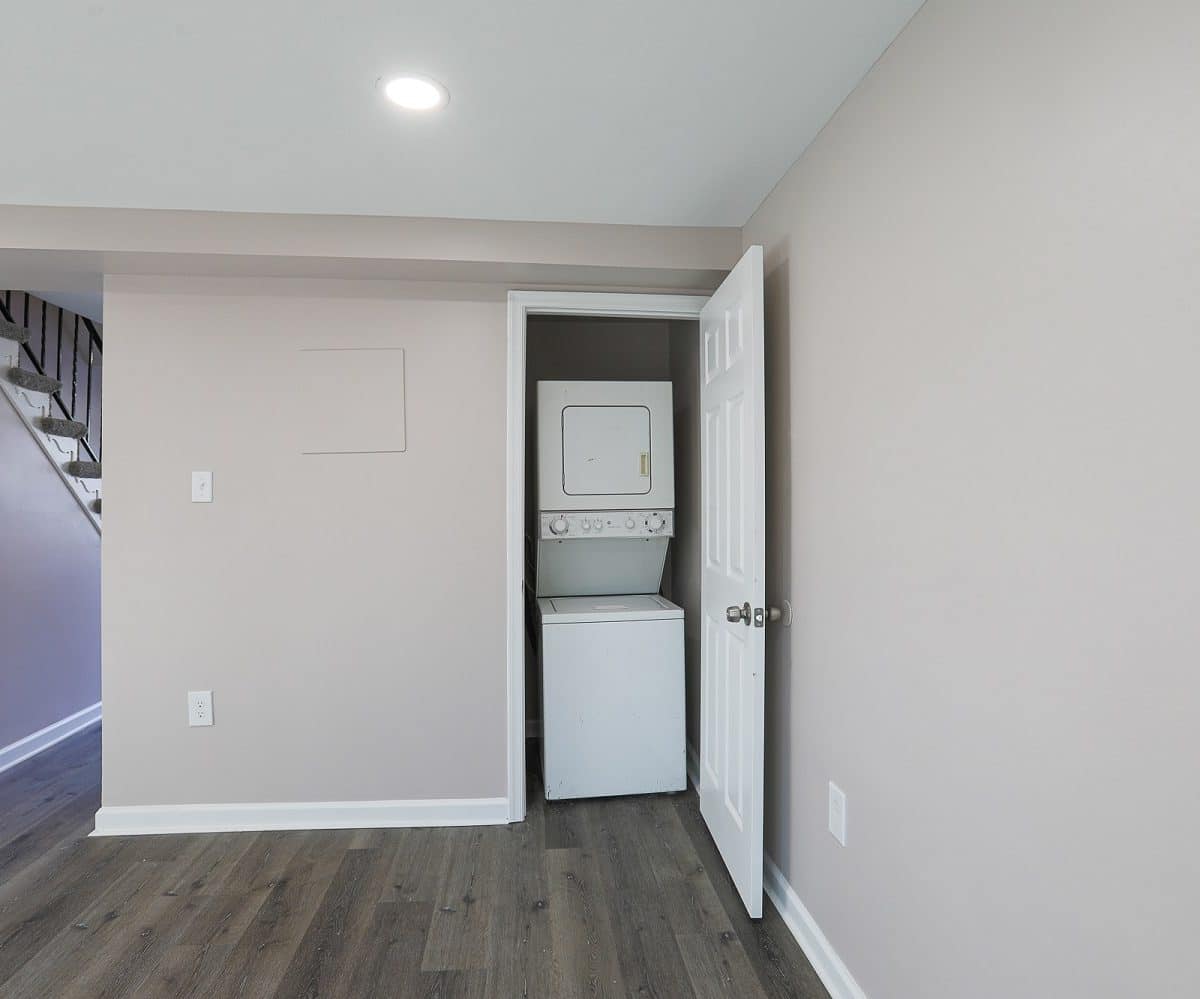 Living room with washer and dryer in closet.