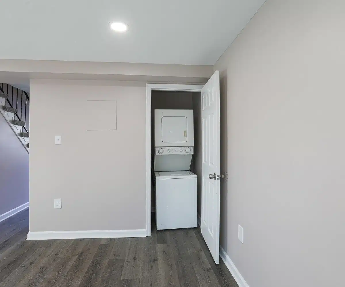 Living room with washer and dryer in closet.