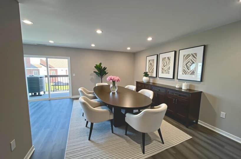 Spacious living room with brown oval table and six chairs.