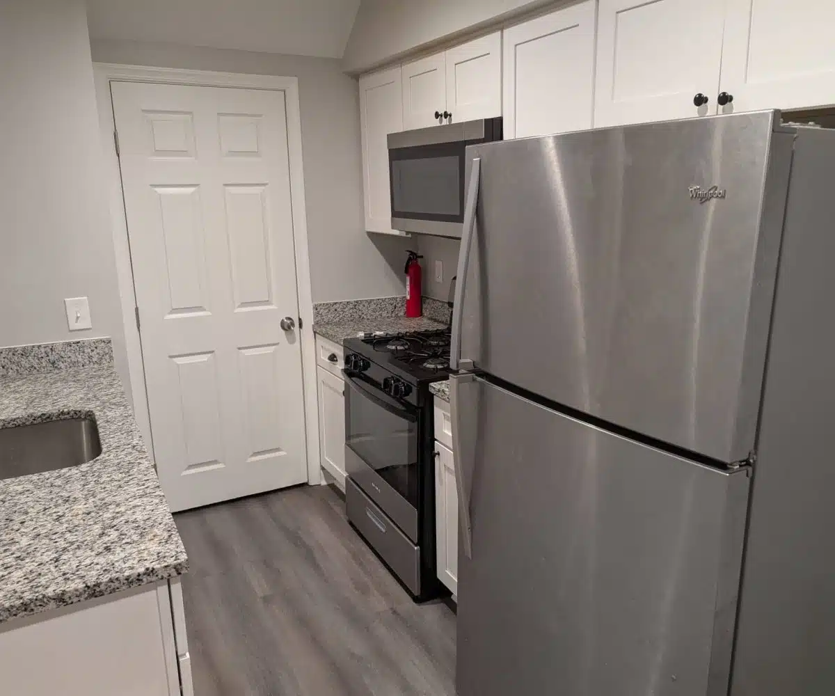 Alameda Kitchen with black oven and grey fridge.