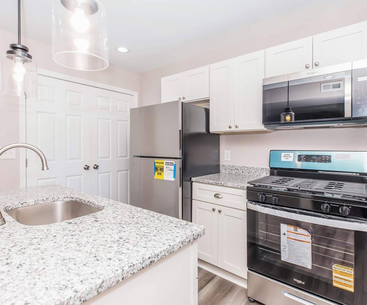 Kitchen with stainless steel appliances and granite countertop.