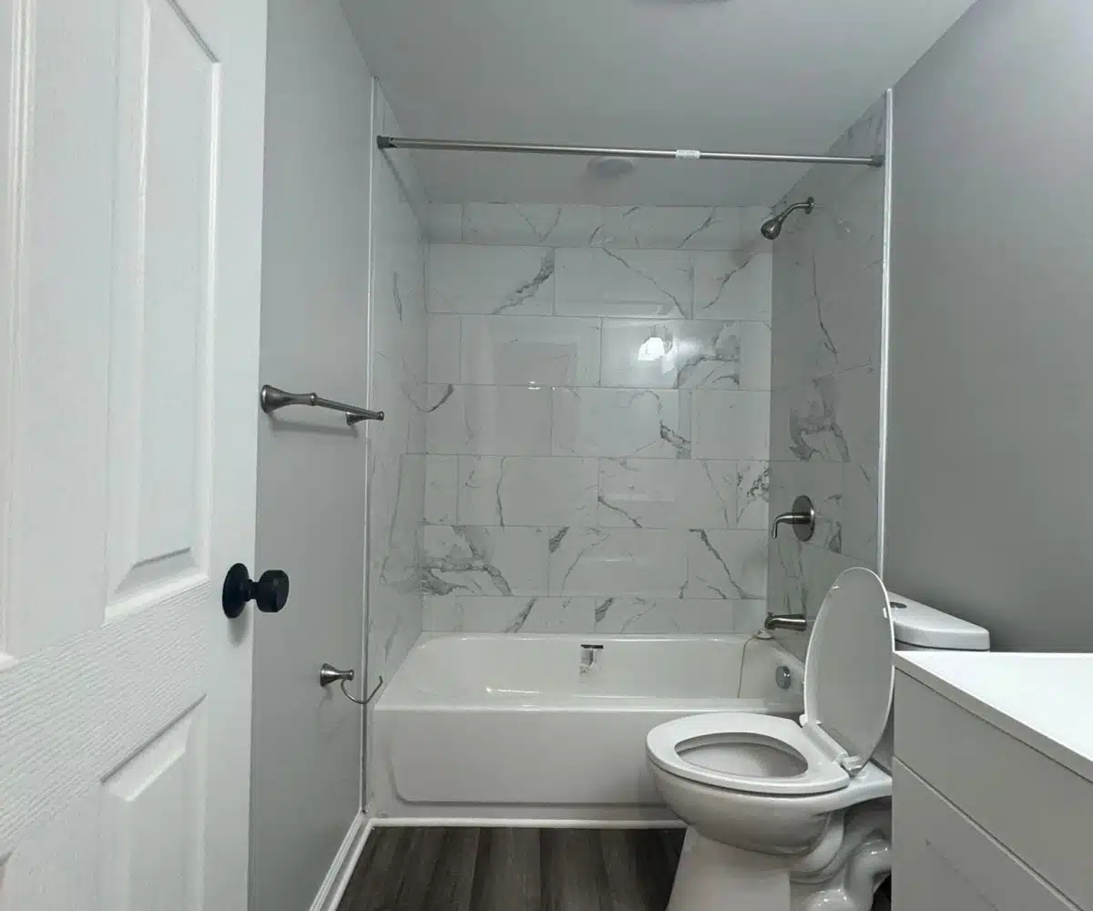 Bathroom with bathrub, toilet and sink.