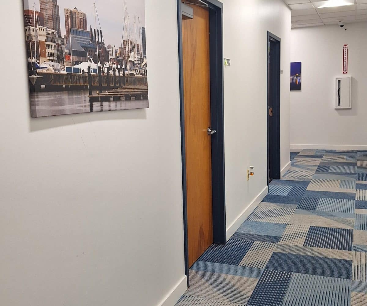 Seton office hall with blue carpeting and wood office doors.