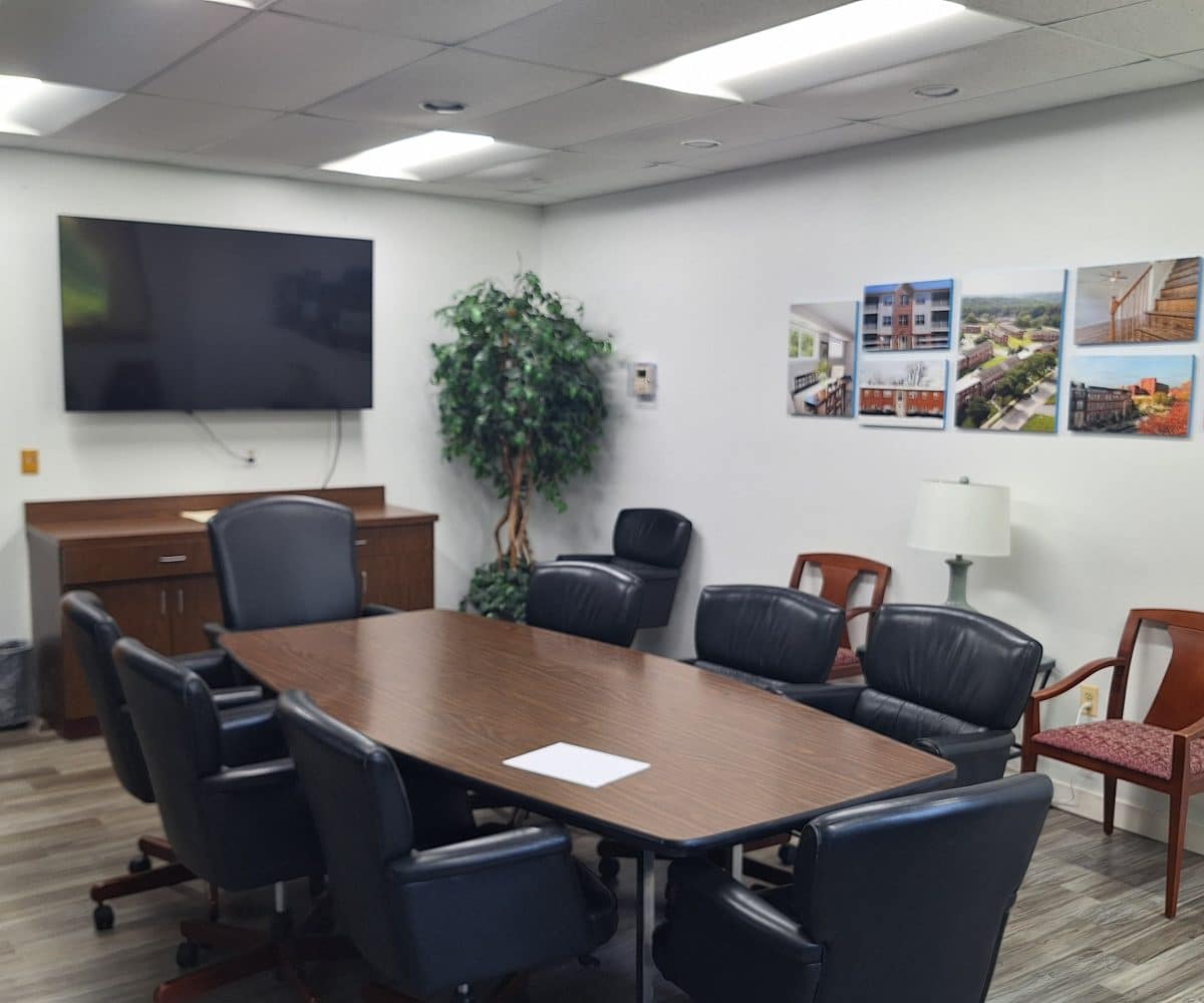 Seton conference room with black chairs, table and computer screen.