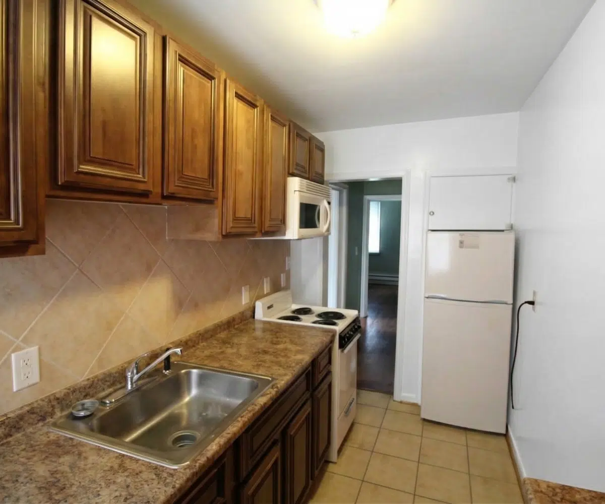 Kitchen at 4111 8th in Baltimore with fridge, oven and sink.