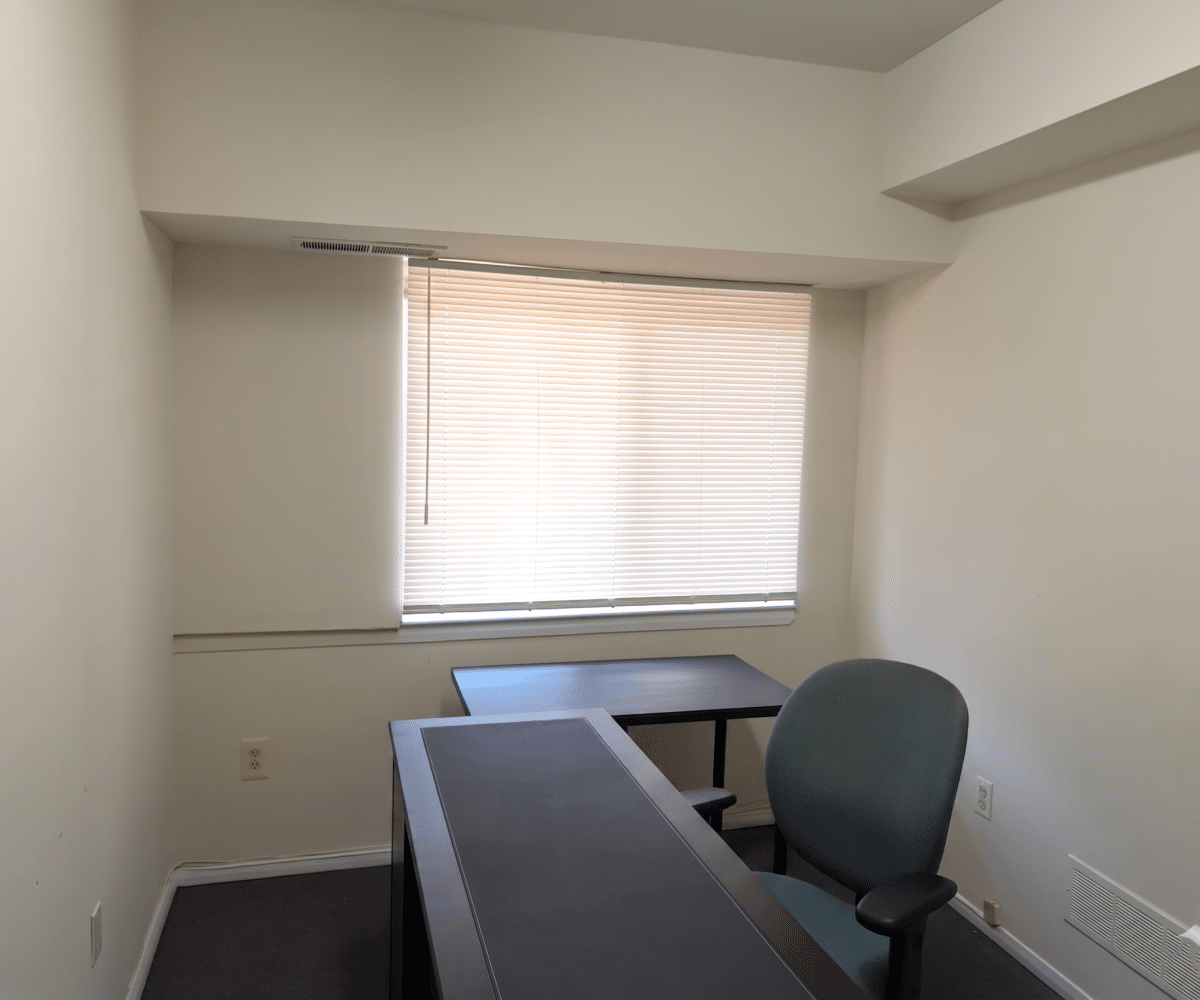 Office with desk and window.