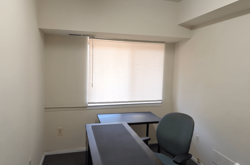 Office with desk and window.
