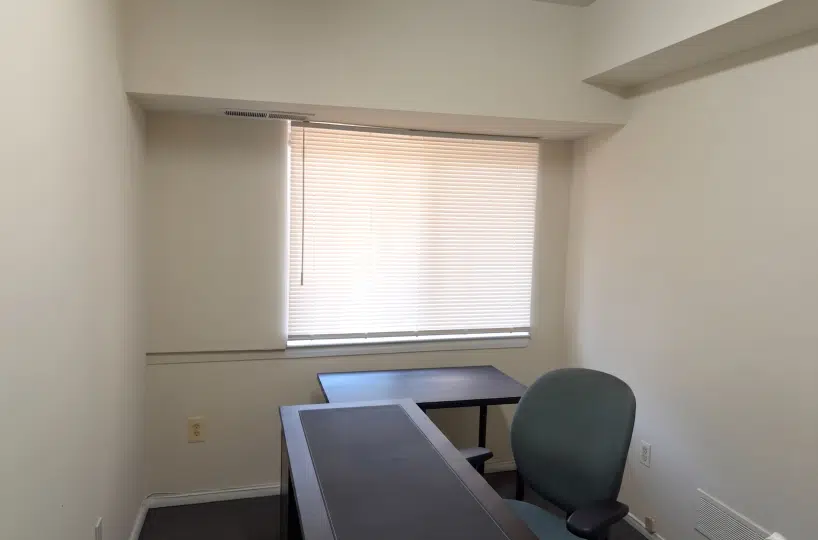 Office with desk and window.